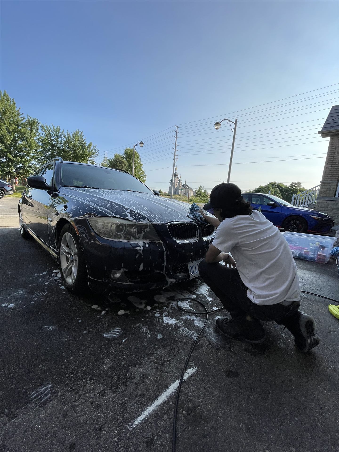 Double A Detailing hand foam washing a BMW on location
